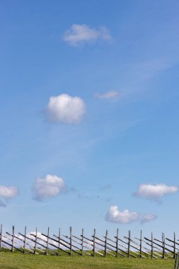 Small, white clouds against a blue sky. clipart