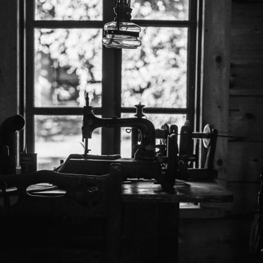 Old sewing machine in black and white photography clipart