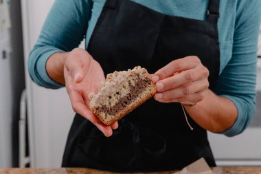 Baker showing off the marbling of a coffee cake slice clipart