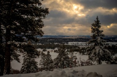 Sunrise over the Pagosa Springs Valley after winter snow storm. clipart