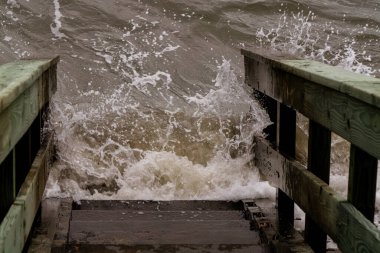 Tides coming in and covering the steps clipart