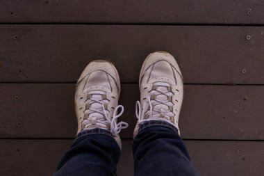 Overhead shot of a person with tennis shoes and jeans clipart