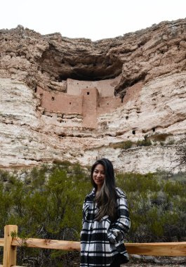 Asian Woman stands in front of Aztec National Monument clipart