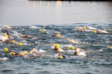 Apple Sprint Triatlonunda açık denizde yüzen bir grup sporcu