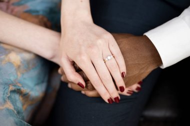 Engaged Couple Holding Hands: Interracial Love clipart