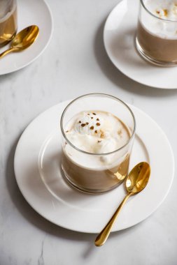 Üç bardakta affogato, üstünde kahve serpiştirilmiş.