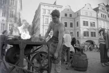 Young blacksmith at work in the city of Prague clipart