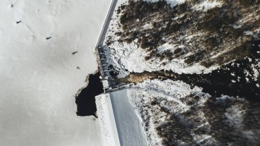 Aerial view of hydroelectric dam and river in winter, Maine clipart