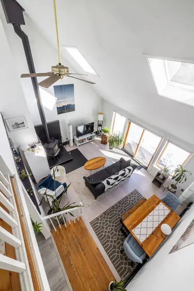 Kanepe ve odun sobasıyla modern oturma odası manzarası.