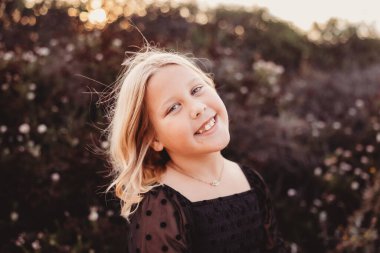 Sarışın kız kameraya gülümsüyor..