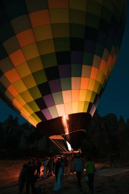 Cappadocia 'da renkli bir sıcak hava balonunu şişirmek için alevler