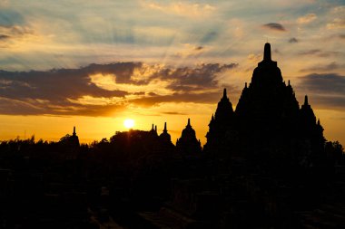 Gün batımında Budist şapşalların siluetleri, Sewu Tapınağı