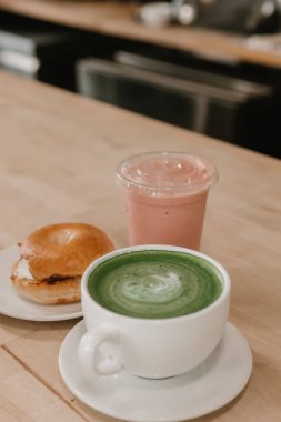 Matcha latte, çilekli smoothie, ve krem peynirli simit.