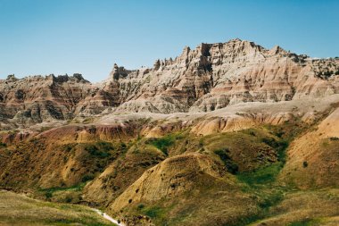 Sarı Tepeler, Çorak Topraklar 'da katmanlı kaya oluşumları ve yeşil yamaçlar.