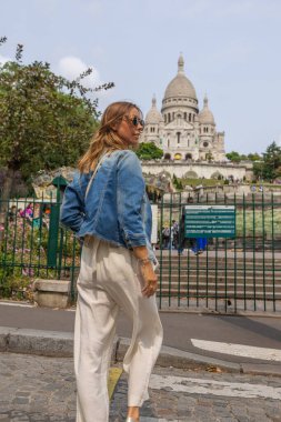 Arka planda Sacre-Coeur ile Montmartre 'ı keşfeden kadın.