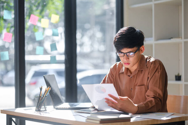 Businessman or student studying online, analyzing financial reports