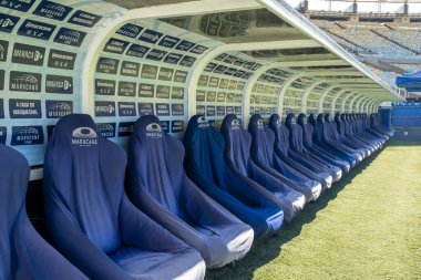 Benches for team coach and substitutes in Maracan soccer stadium.