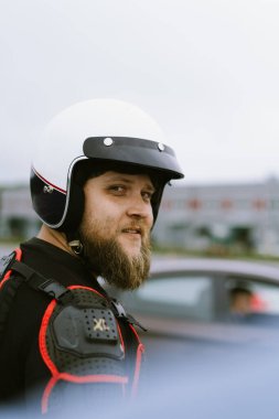 Portia of man race wearing black and white helmet on the racing track