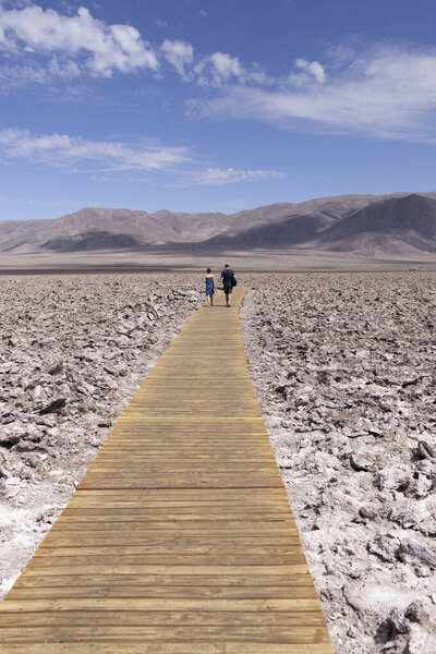 cuuple walking over salt and volcanic field
