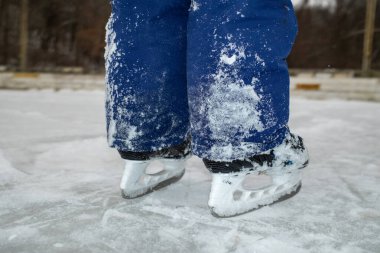 Snow-Covered Ice Skates on a Frozen Rink