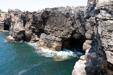 Portekiz, Cascais 'deki Boca do Inferno' daki engebeli kayalıklar ve deniz mağarası.