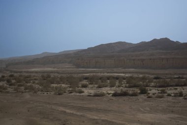 sandy and rocky desert landscape on a clear day