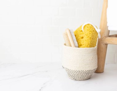 Bright airy bathroom marble and tile shower with natural accessories