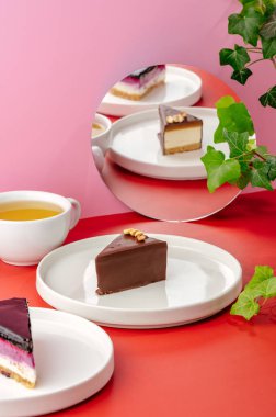 cheesecake on a plate, tea and a mirror