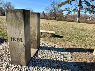 Açık bir gökyüzünün altındaki çimenli alana 