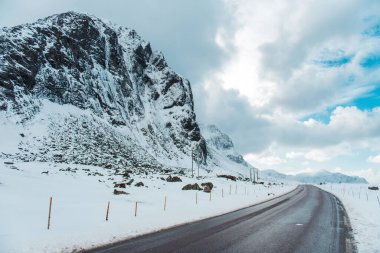 Snowy Mountain Road with Dramatic Sky