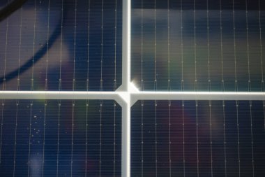 Sun bursting through solar panels in central Texas