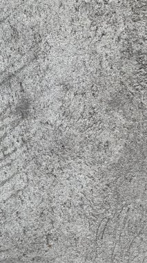 Beton zeminde yaşlılık izleri var ve soyut bir model. Resmin ortasında boş bir alan var..