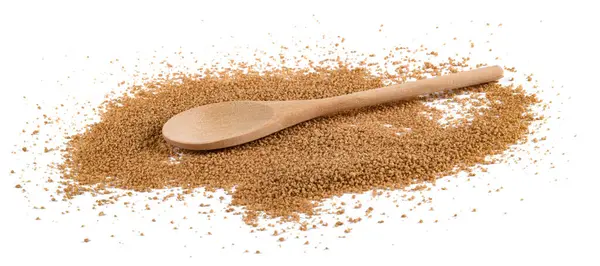 stock image  Cous Cous heap with wooden spoon isolated on white