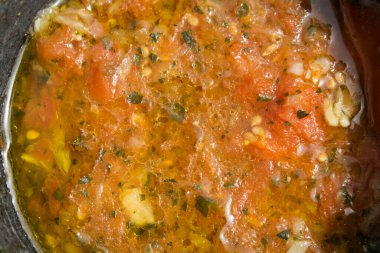 close-up of homemade tomato, garlic, oil and basil based preparationin a mortar for the Italian recipe known as 