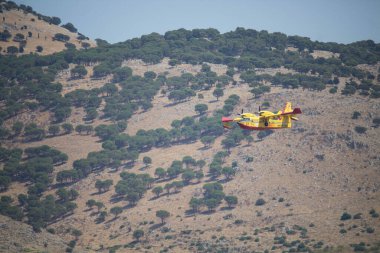 canadair Canadair CL-415 o Viking Air 415 fire extinguishing aircraft in action with clear blue skies
