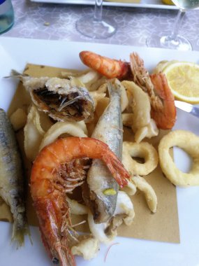 close-up of a plate of mixed fried fish