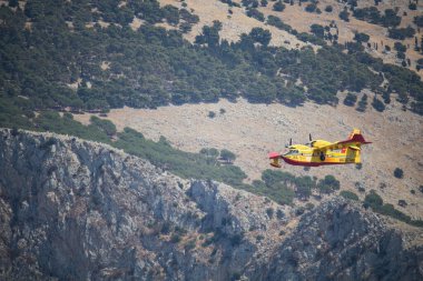 Canadair CL-415 or Viking Air 415_09 fire extinguishing aircraft in action with clear blue skies