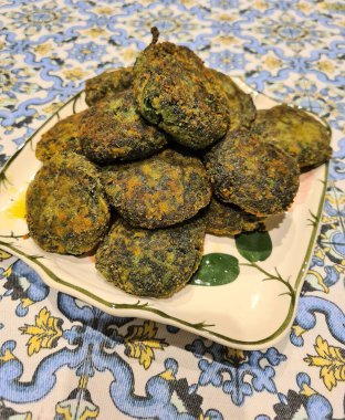 Homemade dish of spinach meatballs with egg, breadcrumbs, cheese and salt