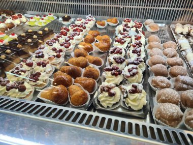 evocative image of typical Sicilian pastry cakes and ice creamsin an ice cream shop window