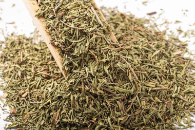 Dried thyme on a white background, creating a high-contrast image. Thyme is a popular herb used in cooking and its dried form is often used in seasoning dishes