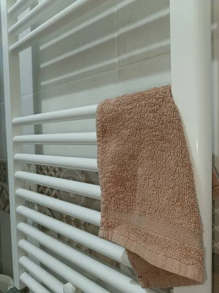 Towel Hanging on a White Towel Rack in a Bathroom