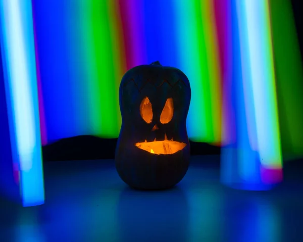 Jack-o-lantern glow in the dark against the backdrop of a rainbow. Halloween decoration