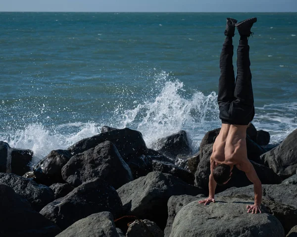 Ατρόμητος Άντρας Κάνει Κατακόρυφο Βράχους Δίπλα Στη Θάλασσα — Φωτογραφία Αρχείου