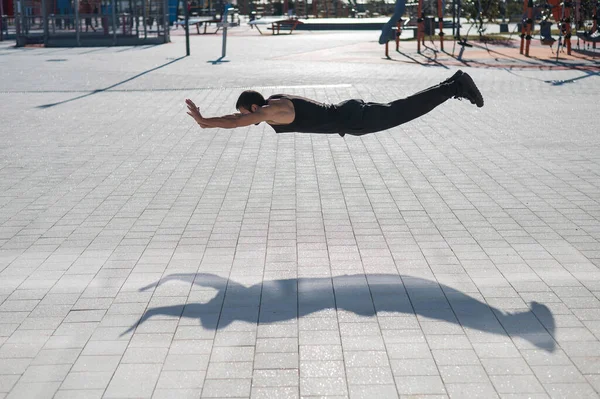 Ein Mann Schwarzer Sportbekleidung Springt Beim Liegestützen Freien — Stockfoto