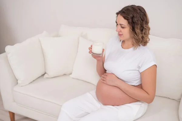 Těhotná Žena Sedí Bílé Pohovce Pije Mléko — Stock fotografie