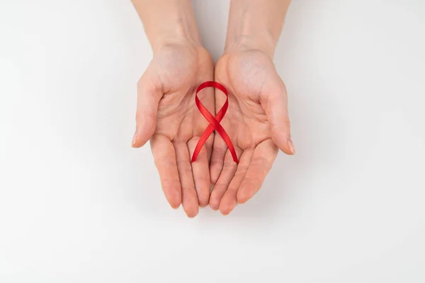 Kobiece Ręce Czerwoną Wstążką Białym Tle Symbol Walki Aids — Zdjęcie stockowe