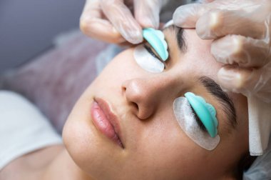 Sahip, müşteriye kirpikleri kaplamak için özel bir silindir takar