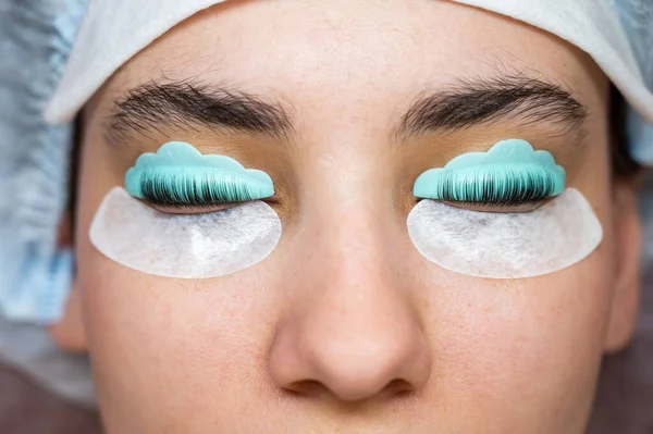 Profile of a woman in a beauty salon on the procedure of eyelash lamination