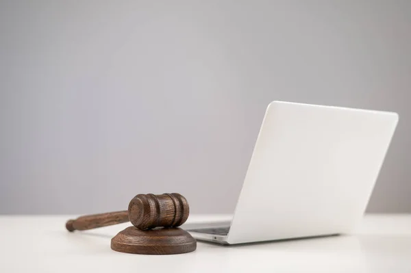 Judicial gavel and laptop on white background