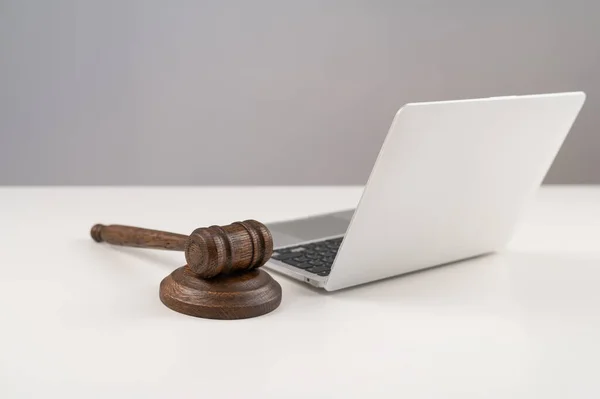Judicial gavel and laptop on white background